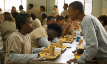 FILE - In this file image released by Netflix, Uzo Aduba, left, and Samira Wiley appear in a scene from "Orange is the New Black." It took less than a decade for leader Netflix to skyrocket from about 12 million U.S. subscribers at the decade's start to 60 million this year and 158 million worldwide. (Jojo Whilden/Netflix via AP, File)