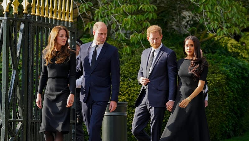 Britain's Prince William, second left, Kate, Princess of Wales, left, Britain's Prince Harry, second right, and Meghan, Duchess of Sussex, view the floral tributes for the late Queen Elizabeth II outside Windsor Castle, in Windsor, England, on Sept. 10, 2022. Kate shared a health update on Friday, March 22, 2024, revealing that she has been diagnosed with cancer and is currently undergoing treatment.