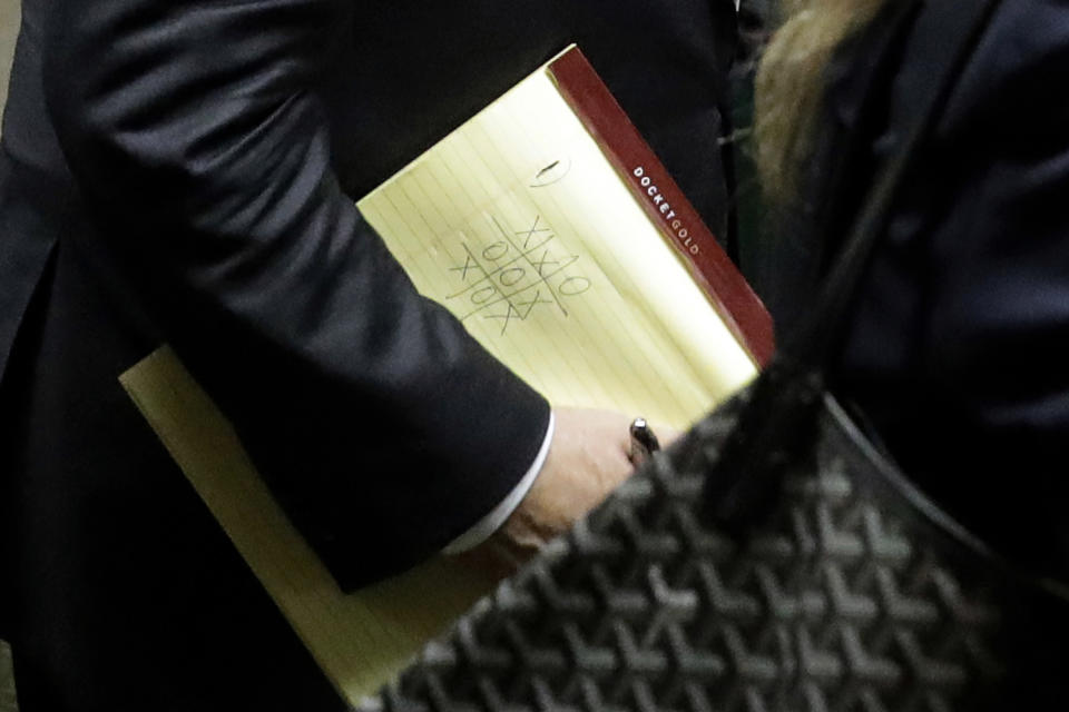 Former movie mogul Harvey Weinstein, carrying a pad with a Tic-Tac-Toe game, leaves State Supreme Court following a hearing related to his sexual assault case, Thursday, July 11, 2019, in New York. Weinstein's lawyer Jose Baez went to court Thursday to get a judge's permission to leave the case, the latest defection from what was once seen as a modern version of O.J. Simpson's "dream team" of attorneys. (AP Photo/Richard Drew)