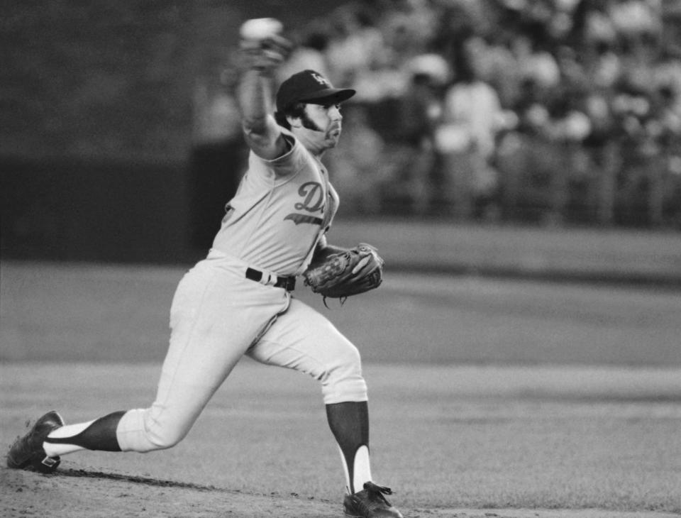 FILE - In this August 1974 file photo, Los Angeles Dodgers pitcher Mike Marshall throws to a New York Mets batter during a baseball game in New York. Marshall, who became the first reliever to win the Cy Young Award while pitching for the Dodgers and eight other major league teams in both leagues, has died. Marshall, 78, died Monday night, May 31, 2021, in Zephyrhills, Fla., according to the Dodgers, who spoke Tuesday to his daughter, Rebekah. She said he had been in hospice care, but did not give a cause of death. (AP Photo/Richard Drew, File)