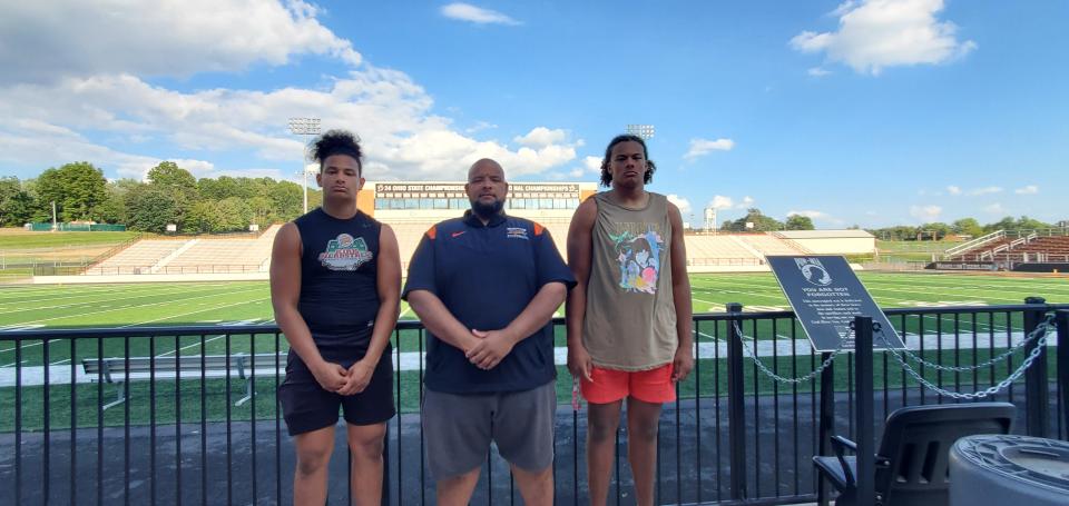 Dewayne Zimmerman (middle) poses for a photo with his sons Deangelo Zimmerman (left) and Chase Bond at Paul Brown Tiger Stadium.
