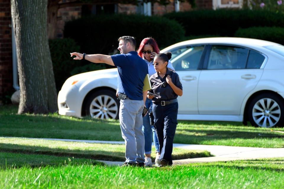 Detroit Police and investigators look over a shooting scene on Pennington Drive, north of Seven Mile Road, Sunday, Aug. 28, 2022, in Detroit (AP)