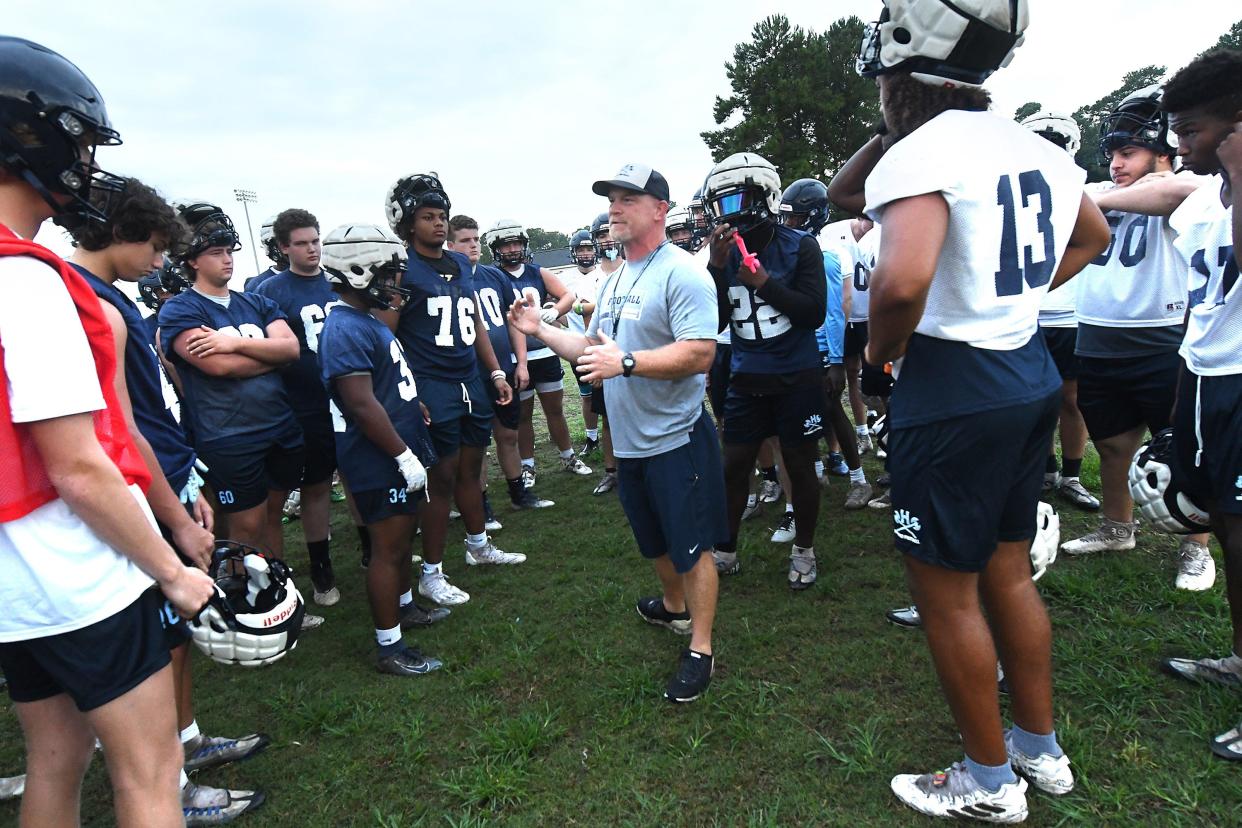 Hoggard Coach Craig Underwood talks to his team Monday morning July 31, 2023 in Wilmington, N.C. High School football started Monday with coaches and players hitting the practice fields across the area. KEN BLEVINS/STARNEWS