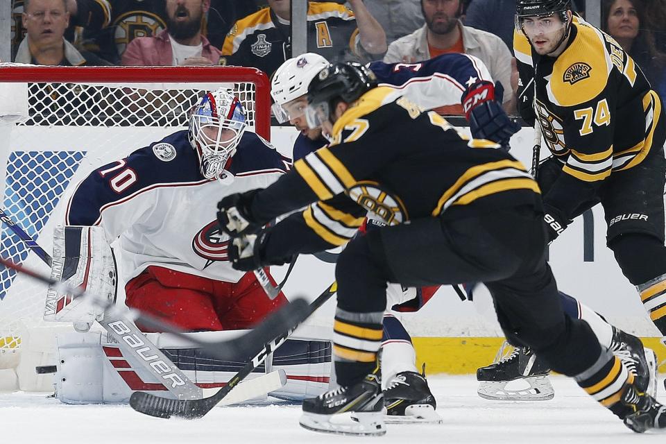 <p>
              Boston Bruins' Patrice Bergeron, foreground, scores on Columbus Blue Jackets' Joonas Korpisalo (70) during the first period of an NHL hockey game in Boston, Saturday, March 16, 2019. (AP Photo/Michael Dwyer)
            </p>