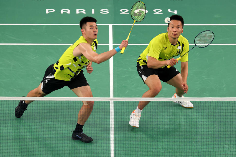 PARIS, FRANCE - AUGUST 04: Chi-Lin Wang plays a backhand as he plays with Yang Lee of Team Chinese Taipei during the Badminton Men's Doubles Gold Medal match against Chang Wang and Wei Keng Liang of Team People’s Republic of China on day nine of the Olympic Games Paris 2024 at Porte de La Chapelle Arena on August 04, 2024 in Paris, France. (Photo by Michael Reaves/Getty Images)