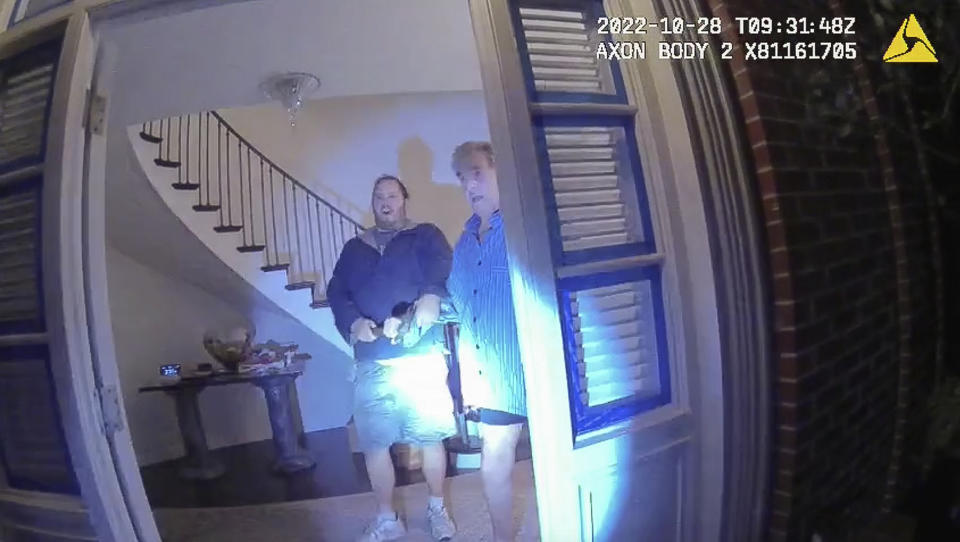 This image from video from police body-worn camera footage, released by the San Francisco Police Department, shows Paul Pelosi, right, fighting for control of a hammer with his assailant, David DePape, during a attack at Pelosi's home in San Francisco on Oct. 28, 2022. DePape wrests the tool from Pelosi and lunges toward him the hammer over his head. The blow to Pelosi occurs out of view of the video as officers rush into the house and subdue DePape. (San Francisco Police Department via AP)