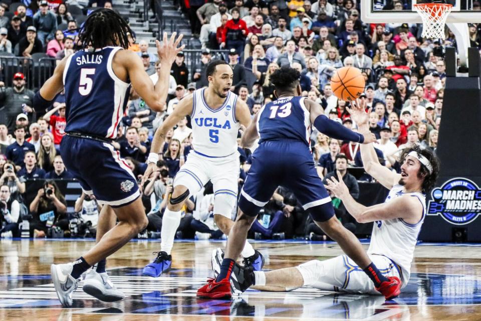 UCLA guard Jaime Jaquez Jr. passes the ball from midcourt.