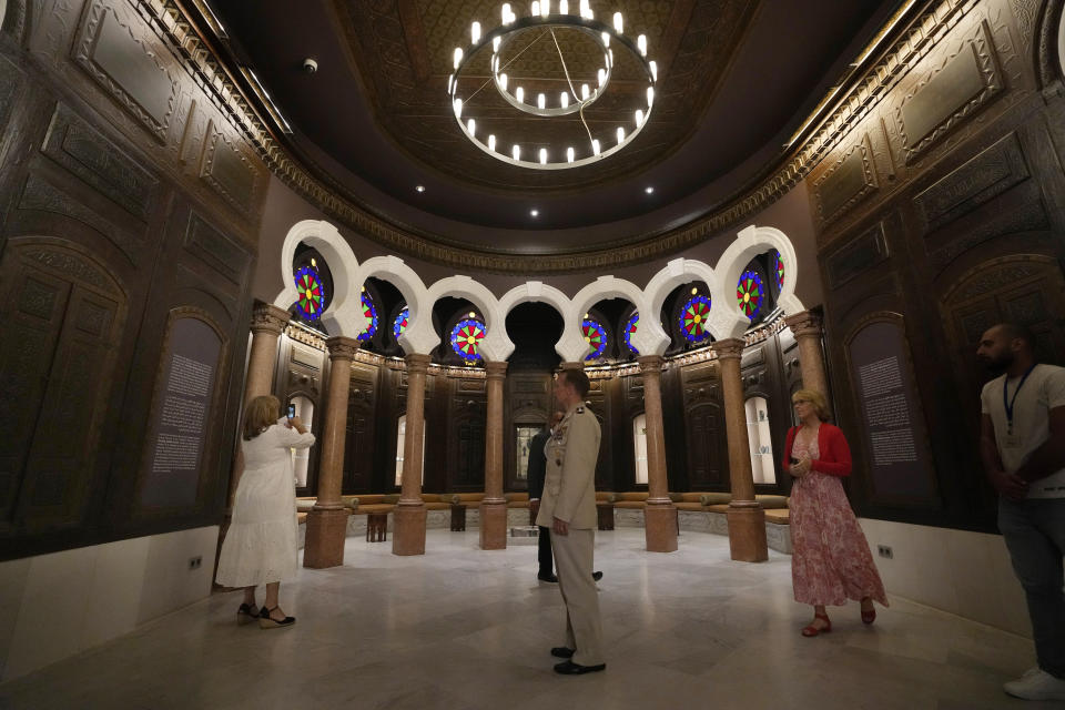 Guests tour the Sursock Museum's exhibitions after relaunching an opening event for the iconic venue in Beirut, Lebanon, Friday, May 26, 2023. The museum has reopened to the public, three years after after a deadly explosion in the nearby Beirut port reduced many of its treasured paintings and collections to ashes. (AP Photo/Hussein Malla)