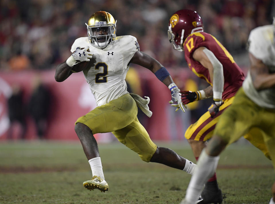 Notre Dame running back Dexter Williams, left, carries the ball as Southern California cornerback Chase Williams defends during the second half of an NCAA college football game Saturday, Nov. 24, 2018, in Los Angeles. Notre Dame won 24-17. (AP Photo/Mark J. Terrill)