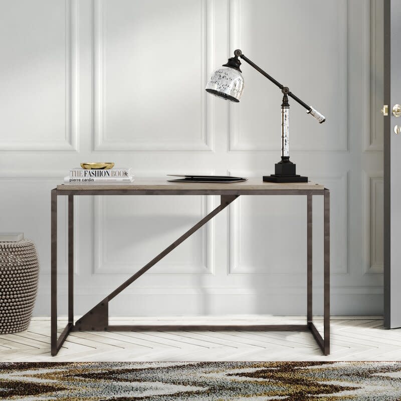 This sleek beauty is 70 percent off—and just the desk for you if your "home office" is also your bedroom or living room. (Photo: Wayfair)