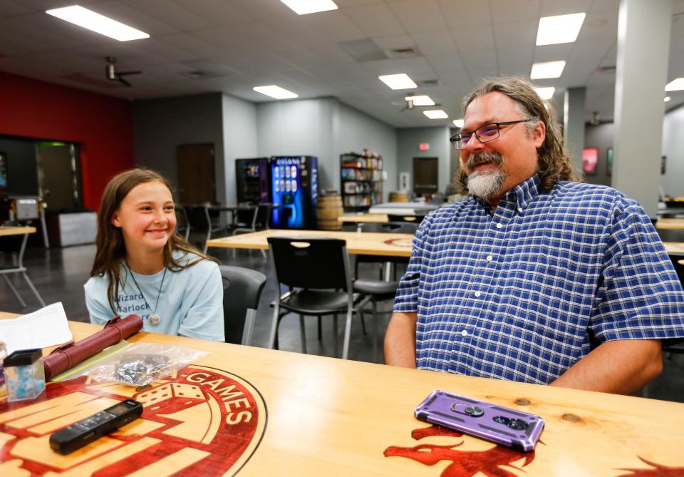 Violet Black and her dad Adam Black talk about playing Dungeons & Dragons together at Meta-Games Unlimited on Monday, July 3, 2023.