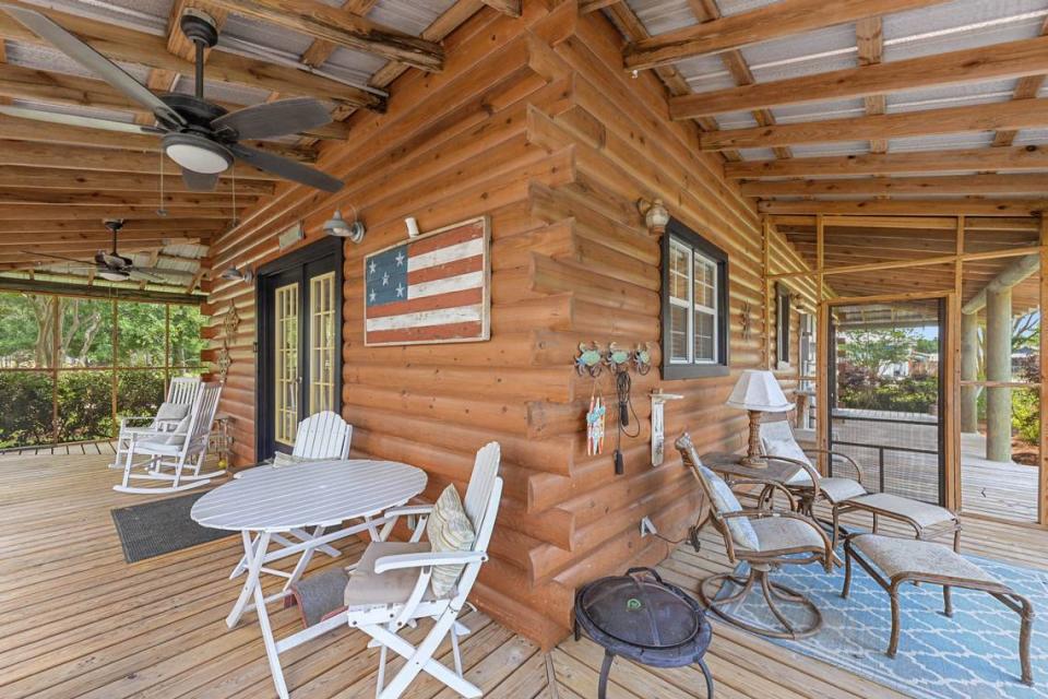 The Waveland home known as Breezy Porches features a wraparound porch that is screened on three sides and open in front. The rear entrance, shown here, overlooks a landscaped courtyard. MS Real Estate Photography