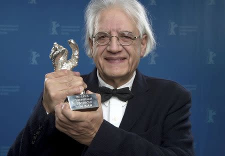 Patricio Guzman poses backstage with his Silver Bear for Best Script for the film 'El boton de nacar', at the awards ceremony of the 65th Berlinale International Film Festival in Berlin February 14, 2015. REUTERS/Tim Brakemeier/Pool