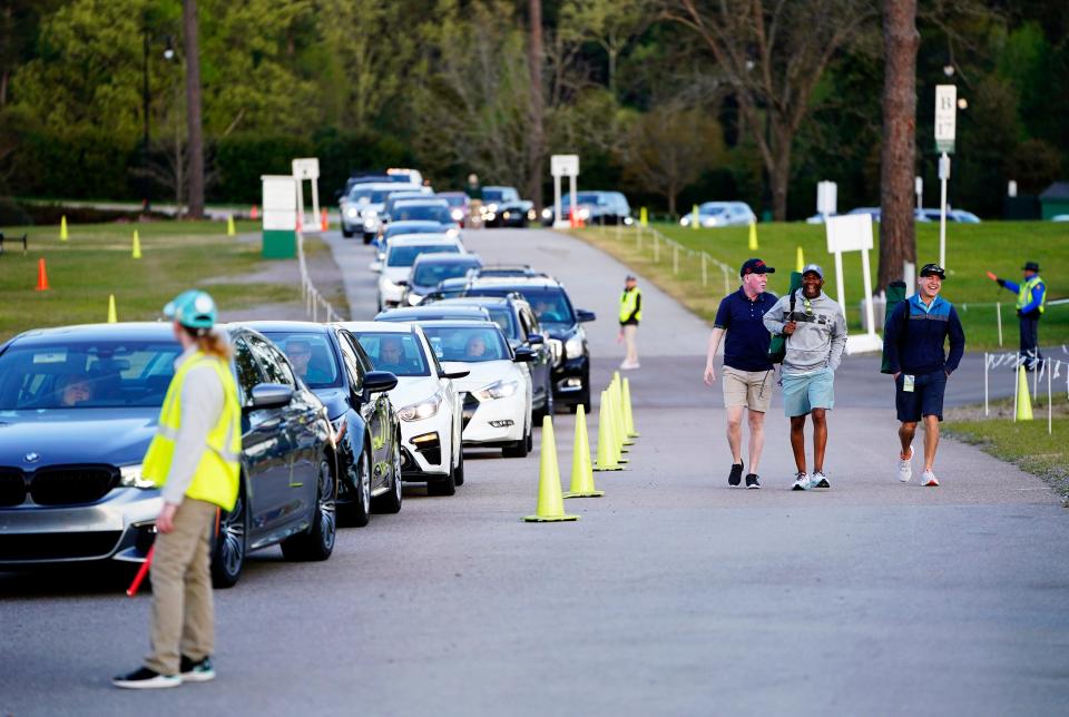 Patrons make their way to parking areas before the Monday practice round of The Masters Tournament at Augusta National Golf Club.