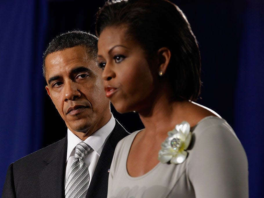 Michelle Obama speaks as Barack Obama looks on.