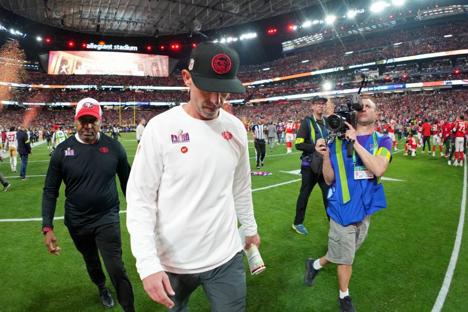 49ers head coach Kyle Shanahan walks off the field after losing Super Bowl 58 to the Chiefs in overtime.