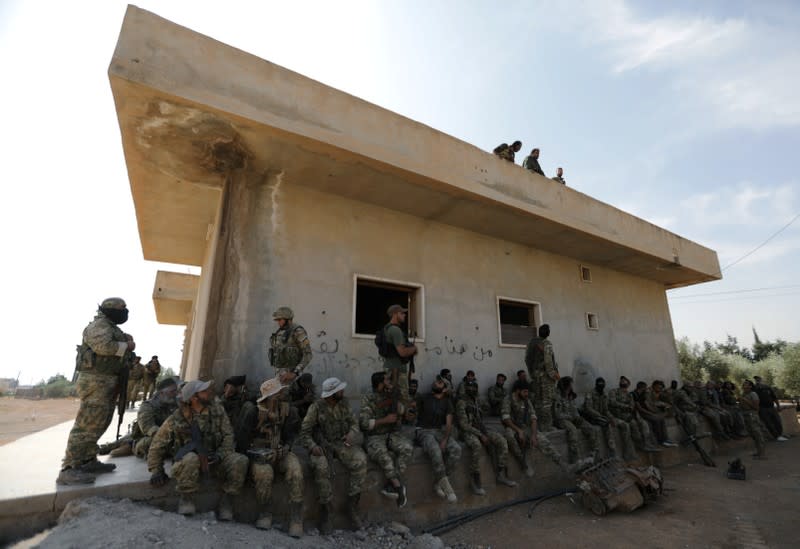 Turkey-backed Syrian rebel fighters gather near the border town of Tal Abyad