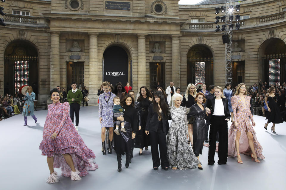 Actresses Aishwarya Rai, from front left, Eva Longoria, carrying her son Santiago Enrique Baston, singer Camila Cabello, actress Dame Helen Mirren, singer Geri Horner, actress Amber Heard and model Doutzen Kroes wear creations as part of the L'Oreal Ready To Wear Spring-Summer 2020 collection, unveiled during the fashion week, in Paris, Saturday, Sept. 28, 2019. (Photo by Vianney Le Caer/Invision/AP)