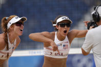 Kelly Claes, left, of the United States, and teammate Sarah Sponcil mug for the camera as they celebrate winning a women's beach volleyball match against Brazil at the 2020 Summer Olympics, Saturday, July 31, 2021, in Tokyo, Japan. (AP Photo/Petros Giannakouris)