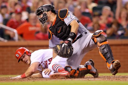 Jun 6, 2018; St. Louis, MO, USA; St. Louis Cardinals right fielder Harrison Bader (48) slides safely into home as \Miami Marlins catcher J.T. Realmuto (11) is unable to put the tag on in time during the fourth inning at Busch Stadium. Mandatory Credit: Scott Kane-USA TODAY Sports