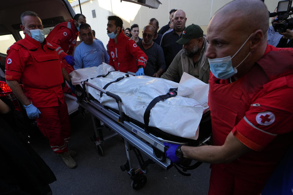 Lebanese Red Cross paramedics carry the body of Farah Omar, a journalist at pan-Arab TV network Al-Mayadeen who was killed by an Israeli strike, at a hospital in Beirut, Lebanon, Tuesday, Nov. 21, 2023. An Israeli strike on southern Lebanon killed Tuesday two journalists reporting for the Beirut-based Al-Mayadeen TV on the violence along the border with Israel, according to the Lebanese information minister and their TV station. (AP Photo/Bilal Hussein)