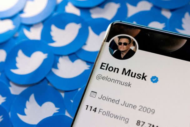 PHOTO: Elon Musk's Twitter profile is seen on a smartphone placed on printed Twitter logos in this picture illustration taken April 28, 2022. (Dado Ruvic/Reuters, FILE)