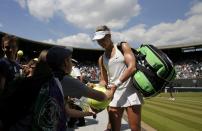 Eugenie Bouchard of Canada signs autographs after defeating Angelique Kerber of Germany in their women's singles quarter-final tennis match at the Wimbledon Tennis Championships, in London July 2, 2014. REUTERS/Suzanne Plunkett (BRITAIN - Tags: SPORT TENNIS)