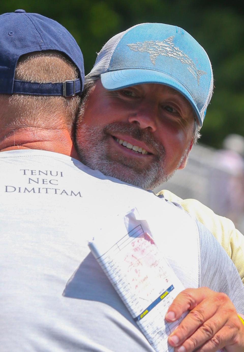 Salesianum head coach Bob Healy receives congratulations after his team beat Cape Henlopen 13-11  in the DIAA state high school championship Saturday, June 4, 2022 at Caravel Academy.