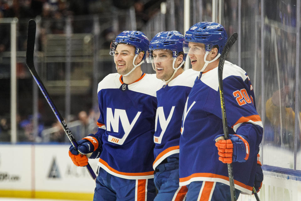 New York Islanders defenseman Ryan Pulock, center, celebrates a goal with his teammates against the Ottawa Senators during the second period of an NHL hockey game Tuesday, Feb. 14, 2023, in Elmont, N.Y. (AP Photo/Eduardo Munoz Alvarez)