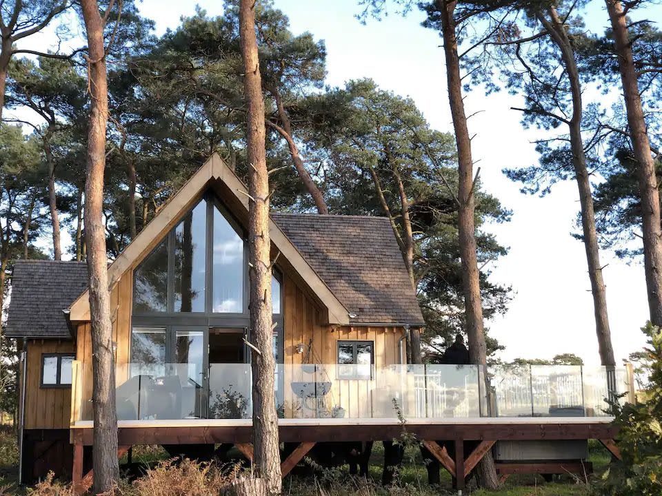 <p><strong>Sleeps:</strong> 6</p><p>An excellent treehouse stay for families, this beautiful lodge in North Norfolk sits among the trees at Happy Valley Norfolk. The treehouse Airbnb has beautiful views across the countryside and the cosy, rustic feel you want from an escape in the woods, with a few luxuries thrown in. <a href="https://airbnb.pvxt.net/9WvMje" rel="nofollow noopener" target="_blank" data-ylk="slk:Toad Hall;elm:context_link;itc:0;sec:content-canvas" class="link ">Toad Hall</a>'s sunken hot tub, decking and huge windows help create the perfect atmosphere for a holiday where you can appreciate the great outdoors.</p><p><a class="link " href="https://airbnb.pvxt.net/9WvMje" rel="nofollow noopener" target="_blank" data-ylk="slk:SEE INSIDE;elm:context_link;itc:0;sec:content-canvas">SEE INSIDE</a></p>