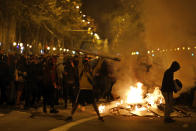 Protestors start fires in the street during clashes with police in Barcelona, Spain, Wednesday, Oct. 16, 2019. Spain's government said Wednesday it would do whatever it takes to stamp out violence in Catalonia, where clashes between regional independence supporters and police have injured more than 200 people in two days. (AP Photo/Emilio Morenatti)