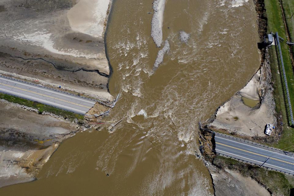 Flood damage to Michigan Highway 30 is seen at Wixom Lake in Michigan, on Wednesday, May 20, 2020, where floodwaters took out the bridge. (Neil Blake/The Grand Rapids Press via AP)