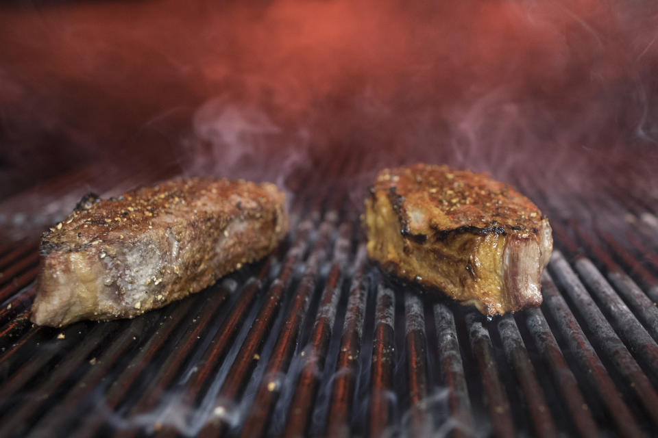 FILE - This Nov. 27, 2018 file photo shows steaks on a grill in New York. (AP Photo/Mary Altaffer, File)