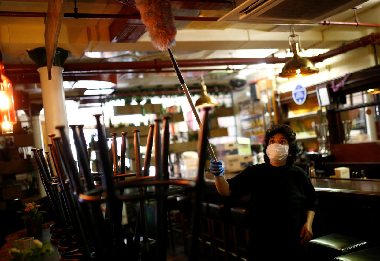 A worker cleans at Cafe Pacifico during preparations for its reopening, amid the coronavirus disease (COVID-19) outbreak, in Covent Garden, in London, Britain, June 29, 2020. REUTERS/Henry Nicholls