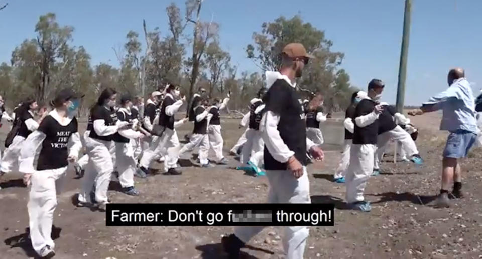 An enraged Queensland farmer can be heard screaming at protesters as they climb through the fence in March. Source: Facebook/Ryan MH