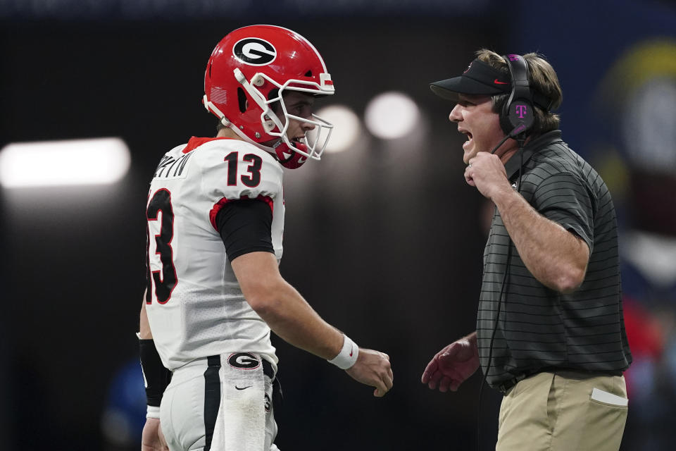 Georgia head coach Kirby Smart speaks on the field during the first half of the Southeastern Conference championship NCAA college football game against Alabama, Saturday, Dec. 4, 2021, in Atlanta. (AP Photo/John Bazemore)