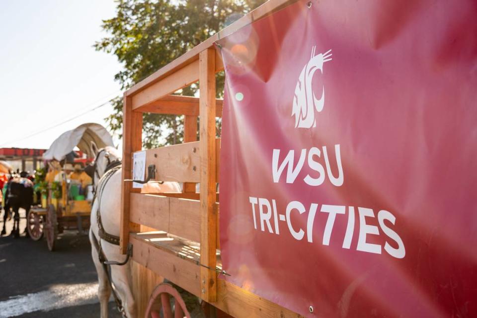 A banner is displayed on a carriage during the 2023 Westward Ho! Parade in Pendleton, Ore.