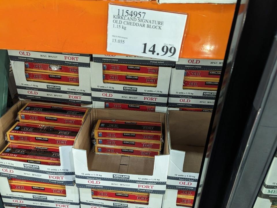 Blocks of cheddar cheese on display at Costco