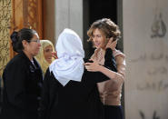 In this photo taken on March 21, 2014, posted on the official Facebook page of the Syrian Presidency, Syrian first lady Asma Assad, right, greets mothers of people missing and killed in the war, on Mother's Day, in Damascus, Syria. As Syrian army made gains on the battlefield, Assad's Britain-born wife has come out of seclusion, joining her husband's campaign to infuse confidence and optimism into the war-wrecked nation. Since January, Asma Assad has made several carefully scripted public appearances in the past months. (AP Photo/Syrian Presidency via Facebook)