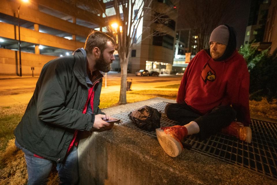 5:25 AM

Joe Newland, left, a volunteer for Coalition for the Homeless' 2020 census, talks with Owen Hogan, who was sleeping on a heating vent on Abraham Flexner Way on Jan. 30, 2020.