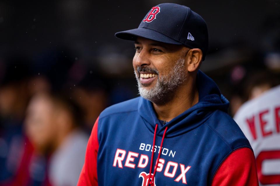 Red Sox manager Alex Cora smiles in the dugout during the fourth inning April 13, 2022 against the Tigers at Comerica Park.