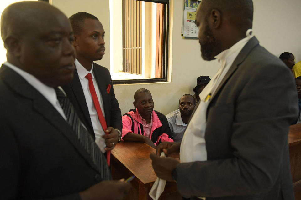 Paul Nthenge Mackenzie (C), looks at his lawyer George Kariuki (R) while appearing in the dock with other co-accused at the court in Malindi on May 2, 2023.<span class="copyright">AFP via Getty Images</span>