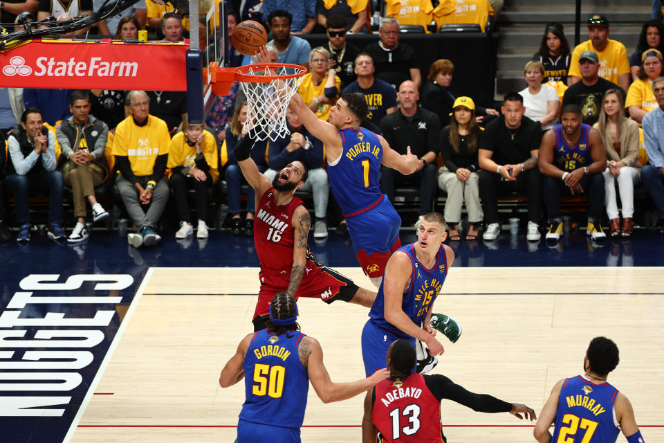 DENVER, COLORADO - JUNE 01: Caleb Martin #16 of the Miami Heat drives to the basket against Michael Porter Jr. #1 of the Denver Nuggets during the first quarter in Game One of the 2023 NBA Finals at Ball Arena on June 01, 2023 in Denver, Colorado. NOTE TO USER: User expressly acknowledges and agrees that, by downloading and or using this photograph, User is consenting to the terms and conditions of the Getty Images License Agreement. (Photo by Jamie Schwaberow/Getty Images)