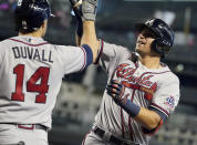 CORRECTS TO AUSTIN RILEY NOT FREDDIE FREEMAN - Atlanta Braves' Austin Riley, right, gets a high-five from Adam Duvall (14) after hitting a two-run home run against the Arizona Diamondbacks during the third inning of a baseball game Thursday, Sept 23, 2021, in Phoenix. (AP Photo/Darryl Webb)