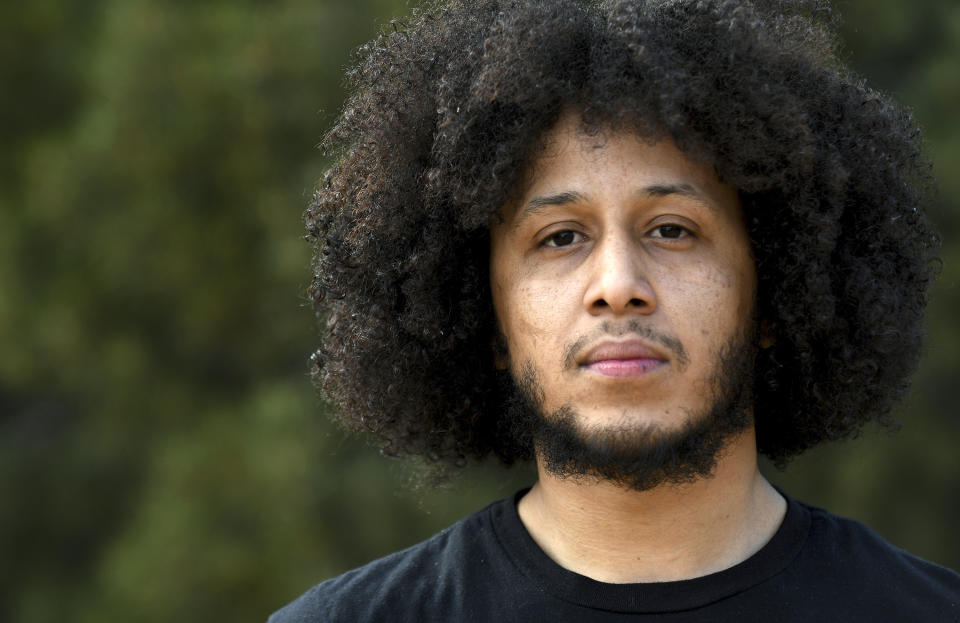 Michael Diaz-Rivera poses for a portrait in Denver on Friday, April 23, 2021. Diaz-Rivera was pulled over in Colorado Springs, Colorado in 2006, and officers found two bags of marijuana in his car. After he was convicted of felony drug possession, he struggled to find housing, ran into hurdles while applying for federal student aid and was denied jobs. Now an elementary school teacher, he sees his future in a pot delivery business made possible by Colorado's marijuana social equity program, which is aimed at correcting past wrongs from the war on drugs. Diaz-Rivera says he hopes his business will allow him to pass on to his children generational wealth that he did not have growing up. (AP Photo/Thomas Peipert)