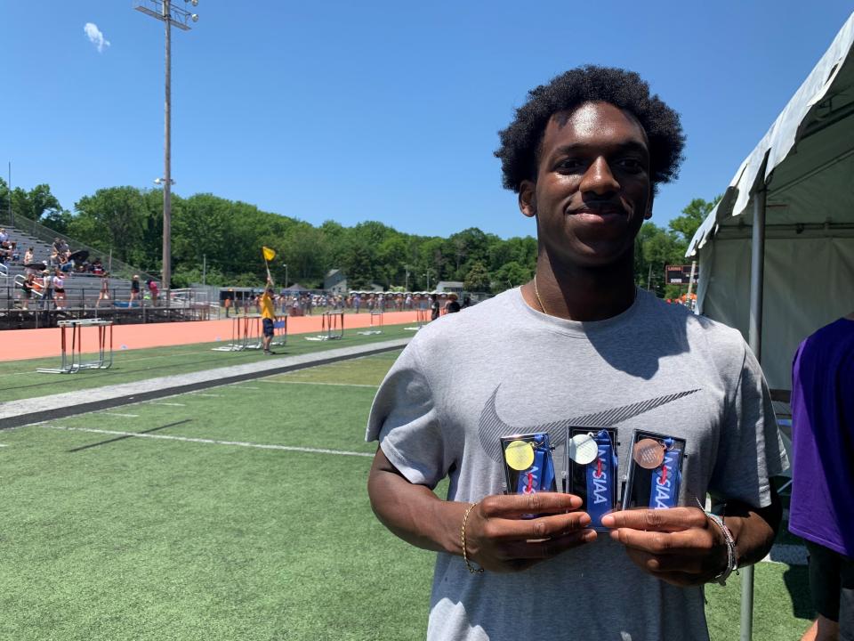 Middletown North's Levi Wilson holds up his medals