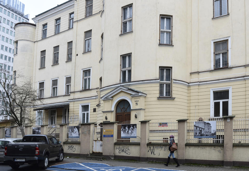 A person walks past the building where the 'Warsaw Ghetto Museum' will be located, in Warsaw, Poland, Friday, Dec. 14, 2018. The Polish government announced plans in March to create a museum dedicated to the Jews imprisoned in the ghetto and tortured and murdered by German forces during their occupation of Eastern Europe. (AP Photo/Alik Keplicz)