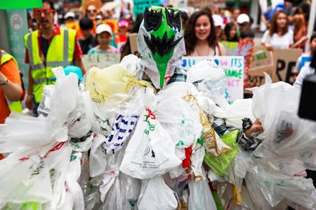 An environmental activist dressed in a costume made with plastic bags participates in a Global Climate Strike near the Ministry of Natural Resources and Environment office in Bangkok