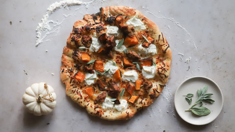 Adding sage leaves to pizza