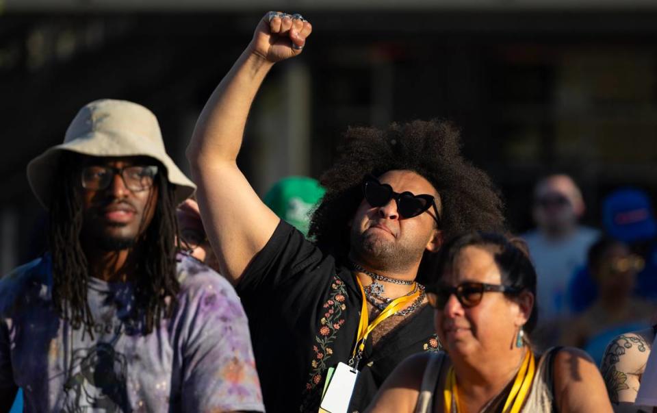 A fan pumps his fist in the air during a set by rapper D Smoke during Elsewhere Fest on Friday.